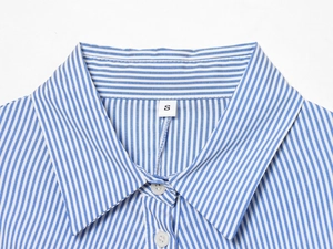 Detail shot of the lapel collar and size S label on blue and white striped shirt