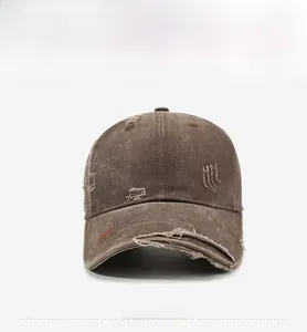 Macro detail of dark brown washed canvas baseball cap with Black Palm embroidery and distressing
