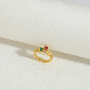 Detailed close-up of 14K gold plated ring with red, green, and purple gemstones