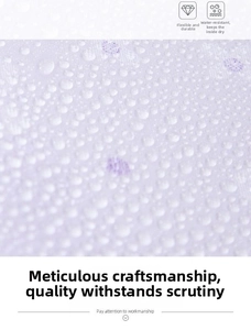 Close-up of waterproof fabric showing water droplets on the matte surface of the beach bag