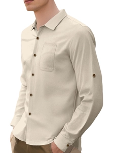 Close-up of beige linen shirt featuring detailed fabric texture and chest pocket