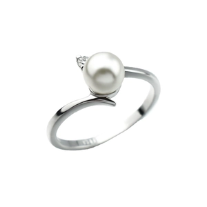 Minimalist silver pearl ring with a round white pearl and a small sparkling side stone