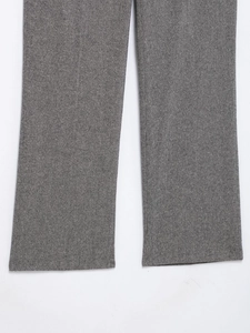 Detailed view of gray melange fabric texture on formal suit trousers for women