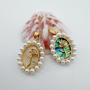 Gold-plated oval rose charms with pearl borders in white shell and abalone inlay styles