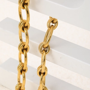 Close-up of 18K gold-plated stainless steel thick chain link necklace on display stand