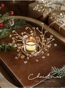 Golden Christmas beaded candle holder on vintage books with festive pine and berry decor