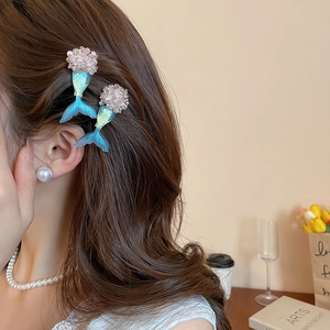 Detail of blue gradient mermaid tail hair clips and large pearl earrings set
