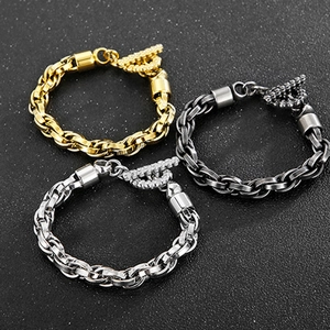 Trois bracelets gourmettes en acier or, argent et noir avec fermoir OT serti de diamants