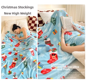 Detailed view of thick light blue flannel blanket with festive reindeer and snowflake patterns