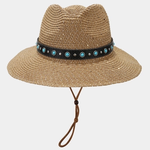 Detail of woven straw hat featuring turquoise beads, silver studs, and leather strap
