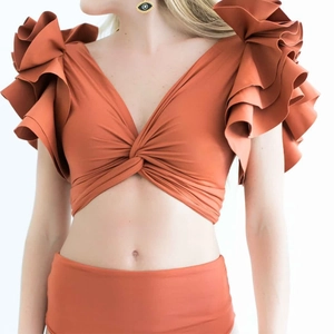Detail of caramel ruffle bikini top with twist knot design and high waisted bottoms