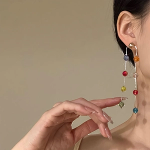 Exquisite colorful glass bead tassel earrings with silver needle on an Asian model