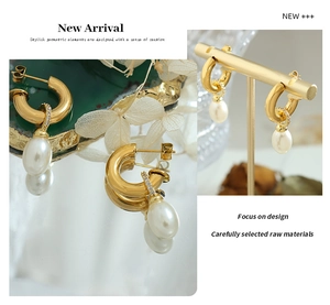 Detailed view of gold C-shape hoop earrings with teardrop pearls and micro-set zircons