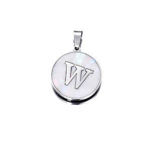 Macro detail of round stainless steel pendant featuring white shell inlay and letter W