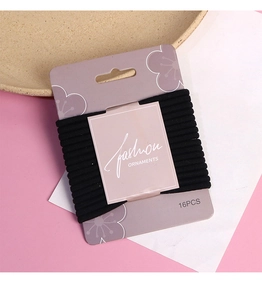 Set of 16 thick high-elastic black hair ties displayed on a floral fashion card organizer