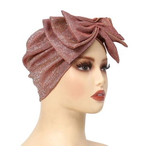 Sparkly rose gold turban hat for women featuring a large handmade glitter bow design