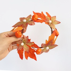 Close-up of maple leaf and pumpkin candle ring with white pearls for fall decor