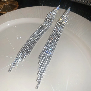 Close-up of dangling rhinestone tassel earrings in silver finish for formal social events