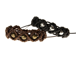 Detail of adjustable woven bracelets in brown and black with metallic beads set