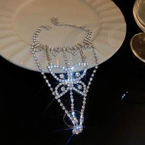 Detailed close-up of a silver butterfly hand chain with sparkling rhinestones on a plate