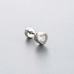 Silver heart stud earring with blue zircon stone and screw back on a grey surface