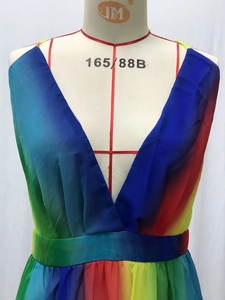 Detail of colorful rainbow gradient pleated fabric with deep V-neck and high waistline