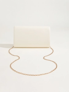 Detail of a minimalist cream PU leather clutch with elegant gold chain strap