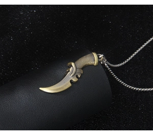 Detail of antique bronze reaper scythe pendant on silver chain over leather