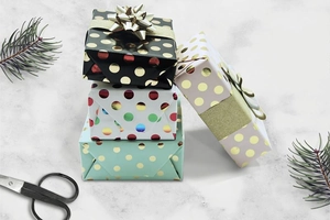 Polka dot gift wrapping paper rolls in black, white, mint, and pink with metallic gold foil