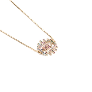 Detailed close-up of golden MOM pendant with colorful zircon stones on thin box chain