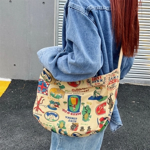 Vintage warm yellow canvas crossbody bag with retro print and large capacity shown on model