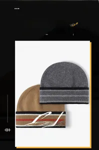 Close-up of winter knit beanies in grey and tan with classic striped hem details