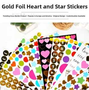 Close-up of gold-stamped heart and star stickers for DIY scrapbooking decoration