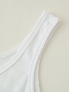 Detailed close-up of the white ribbed knit fabric and double-stitched strap seam