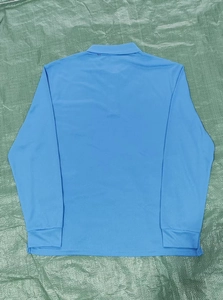 Detail of light blue long sleeve tactical polo shirt showing breathable quick-dry fabric texture