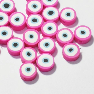 Macro view of 10mm pink evil eye polymer clay beads with detailed concentric circle patterns