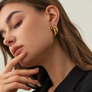 Minimalist 18k gold plated chunky croissant hoop earrings for women on model