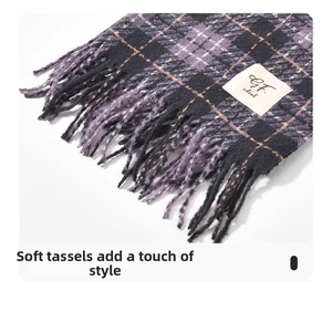 Close-up of soft plaid scarf fringe and texture in purple and black with brand label
