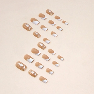 French tip square fake nails with white edges and gold foil flecks on nude base
