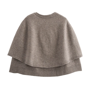 Detail of dark brown knit poncho showing ribbed crew neck and fine wool texture