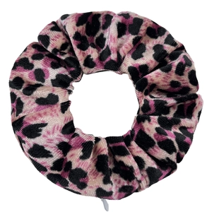 Close-up of pink and black leopard print tie-dye velvet scrunchie with zipper pocket