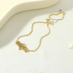 Detail view of gold MAMA bracelet with colorful zircon stones and adjustable box chain