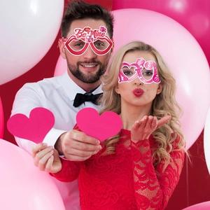 Valentine's Day party heart glasses featuring Be Mine and Kiss Me designs for photo props