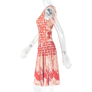 Detail of red and beige geometric print on sleeveless A-line dress with pleated waist