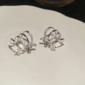 Elegant silver layered butterfly ear cuff with sparkling cubic zirconia on ceramic tray