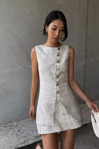 Detail view of linen two-piece set with decorative buttons and textured sleeveless top