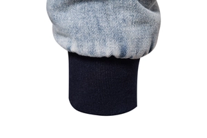Detail of washed denim jacket cuff with dark blue elastic ribbed windproof wrist design