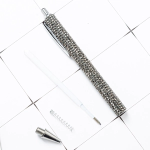 Disassembled view of luxury ballpoint pen with gray rhinestones and metal components