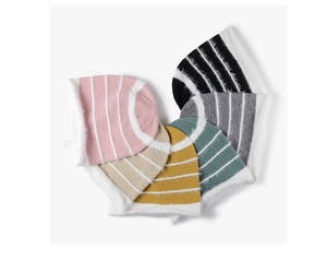 Flat lay detail showing six colorful striped knitted beanies for winter fashion