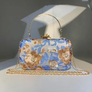 Detail of embroidered floral evening bag with hand-sewn beads, pearls, and gold chain